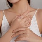 Keresztbe tett női kezeken tündöklő szögletes rózsaszín s925 ezüst gyűrű